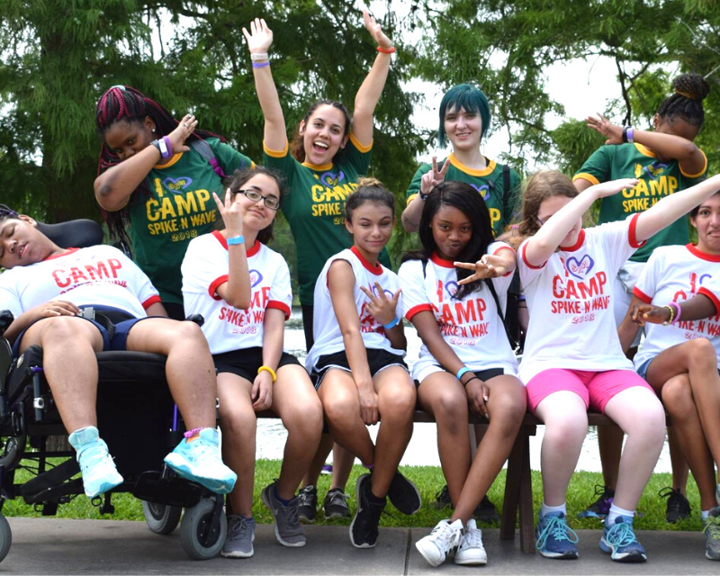 Campers and counselors taking a silly cabin photo at Camp Spike N Wave. Become a camp angel to sponsor campers.
