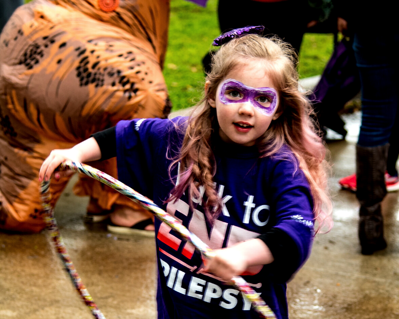 Little girl superhero hula hooping at the 2019 Walk to END EPILEPSY