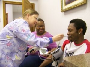 Nurse taking patient's temperature